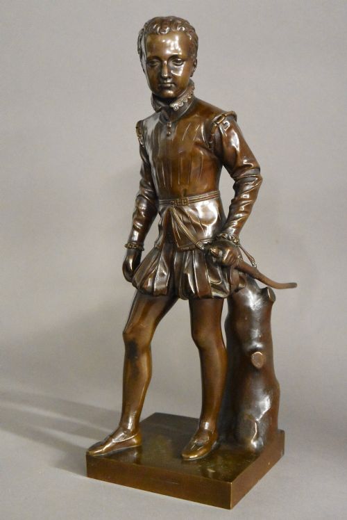 fig 1. A dark brown patinated bronze standing figure of young Henry IV of France dressed in detailed Renaissance attire atop a square plinth.