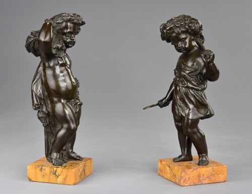 fig 1. A pair of late 19th-century dark bronze figures depicting harvest putti mounted on rectangular yellow marble bases.