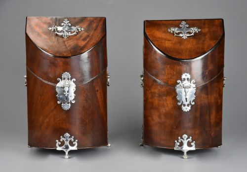 fig 2. A pair of late eighteenth-century bow-front mahogany cutlery boxes with silver mounts and claw feet.
