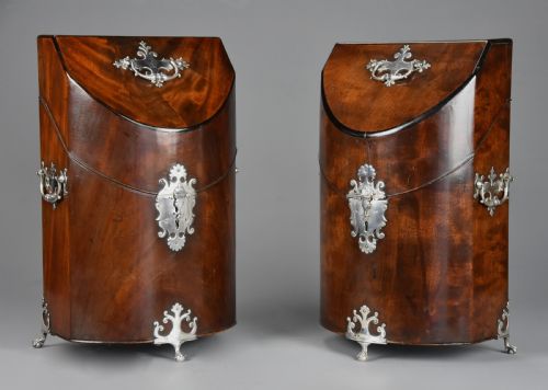 fig 4. A pair of late eighteenth-century bow-front mahogany cutlery boxes with silver mounts and claw feet.