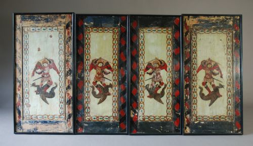 fig 3. A set of four rectangular vertical pine panels decorated with naive paintings of Saint Michael slaying a winged dragon within chainlink borders.