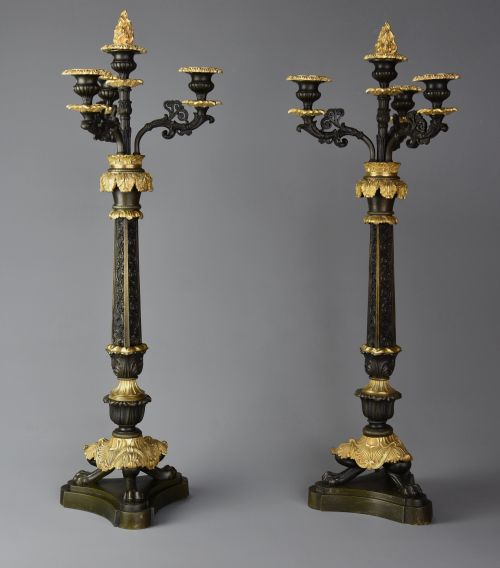 fig 1. A pair of mid-19th century French Regence style candelabra crafted from patinated dark bronze with gilt bronze foliage mounts and three scrolled branches.