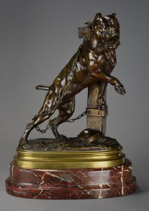 fig 2. A 19th-century dark bronze sculpture of a chained guard dog rearing against a post, mounted on a brass collar and red veined marble base.