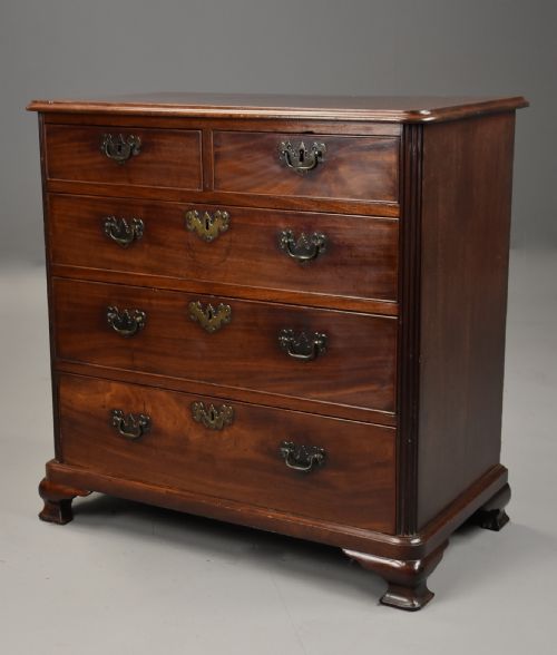 fig 2. A mid-18th century George III mahogany chest of drawers featuring a two short over three long drawer configuration with brass swan-neck handles and bracket feet.