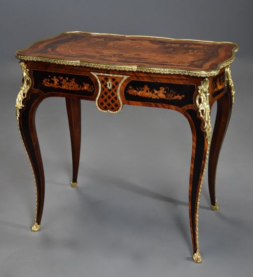 fig 1. A mid-19th-century French Kingwood centre table featuring a serpentine top with intricate pictorial marquetry, cabriole legs, and ornate gilt-bronze mounts.