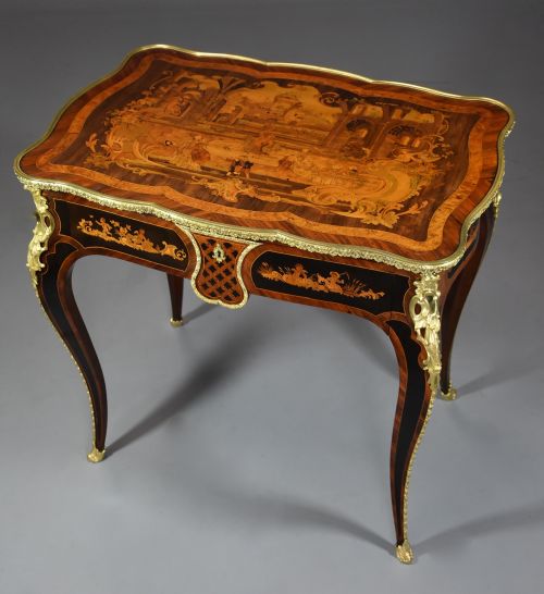 fig 4. A mid-19th-century French Kingwood centre table featuring a serpentine top with intricate pictorial marquetry, cabriole legs, and ornate gilt-bronze mounts.