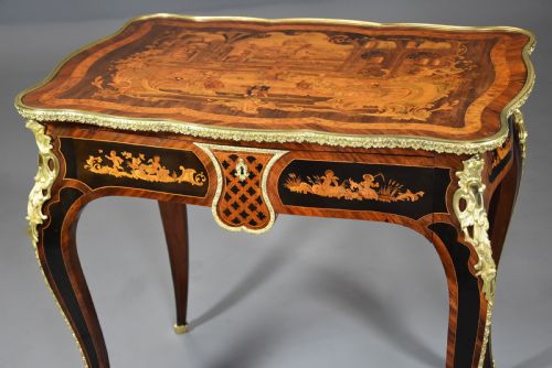 fig 5. A mid-19th-century French Kingwood centre table featuring a serpentine top with intricate pictorial marquetry, cabriole legs, and ornate gilt-bronze mounts.