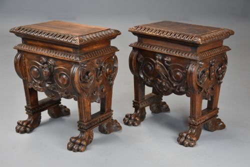 fig 1. A pair of carved warm brown walnut stools with gadrooned tops, central bird reliefs, scrollwork aprons, and paw feet.