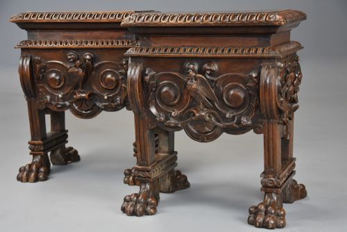 fig 2. A pair of carved warm brown walnut stools with gadrooned tops, central bird reliefs, scrollwork aprons, and paw feet.