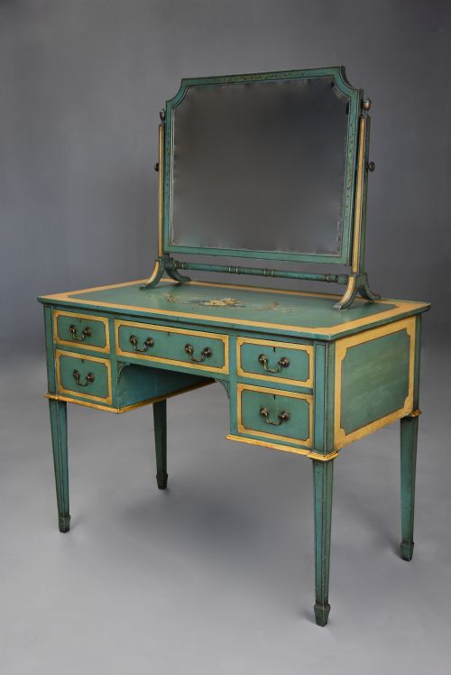 fig 6. An early twentieth-century hand-painted green and gold bedroom suite featuring a wardrobe, chest of drawers with mirror, dressing desk, side tables, and caned chairs decorated with floral urn motifs.