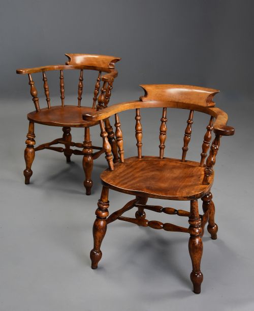 fig 1. A pair of 19th-century birch smokers bow Windsor armchairs featuring steam-bent armrails, turned spindles, saddle seats, and turned legs with stretchers.