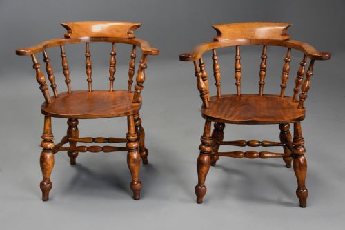 fig 2. A pair of 19th-century birch smokers bow Windsor armchairs featuring steam-bent armrails, turned spindles, saddle seats, and turned legs with stretchers.
