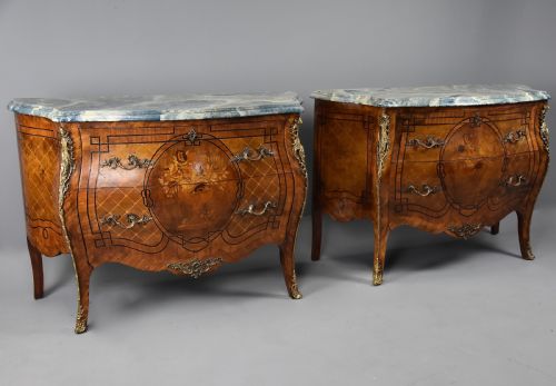 fig 1. A pair of early twentieth-century French Kingwood bombe commodes featuring floral marquetry panels, serpentine blue marble tops, and detailed gilt-bronze mounts.