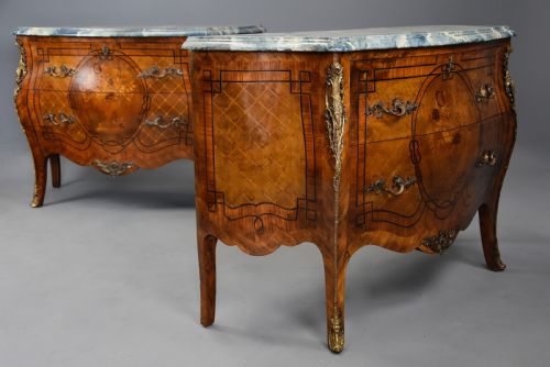 fig 3. A pair of early twentieth-century French Kingwood bombe commodes featuring floral marquetry panels, serpentine blue marble tops, and detailed gilt-bronze mounts.