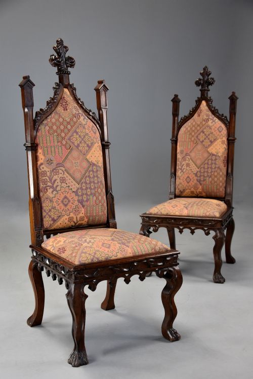 fig 2. A pair of 19th-century rosewood Gothic Revival hall chairs featuring high pointed-arch backs with carved finials and patterned fabric upholstery.
