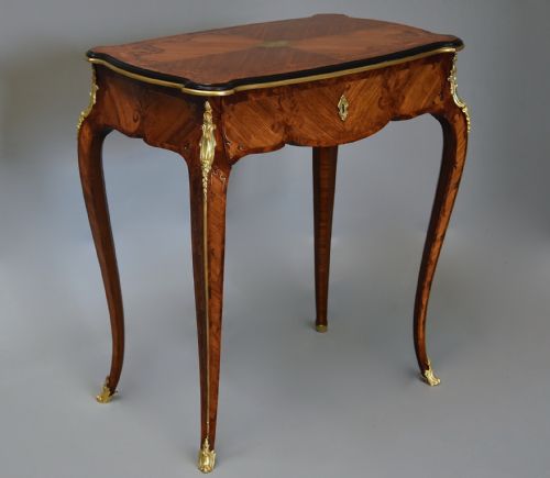 fig 3. A 19th-century French kingwood occasional table featuring cabriole legs, marquetry inlay, serpentine top, and gilt-bronze ormolu mounts.