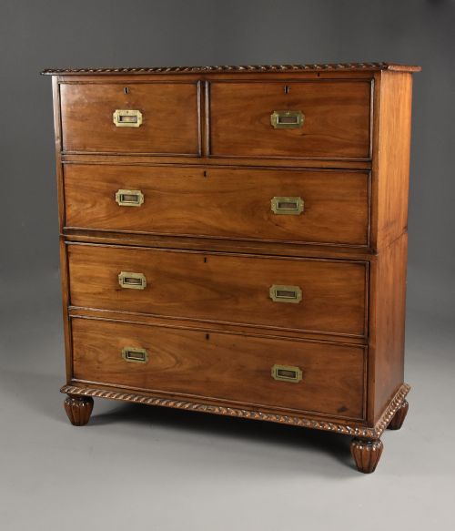 fig 1. A late nineteenth-century padouk military chest of drawers featuring flush brass handles, carved rope-twist borders, and short fluted legs.