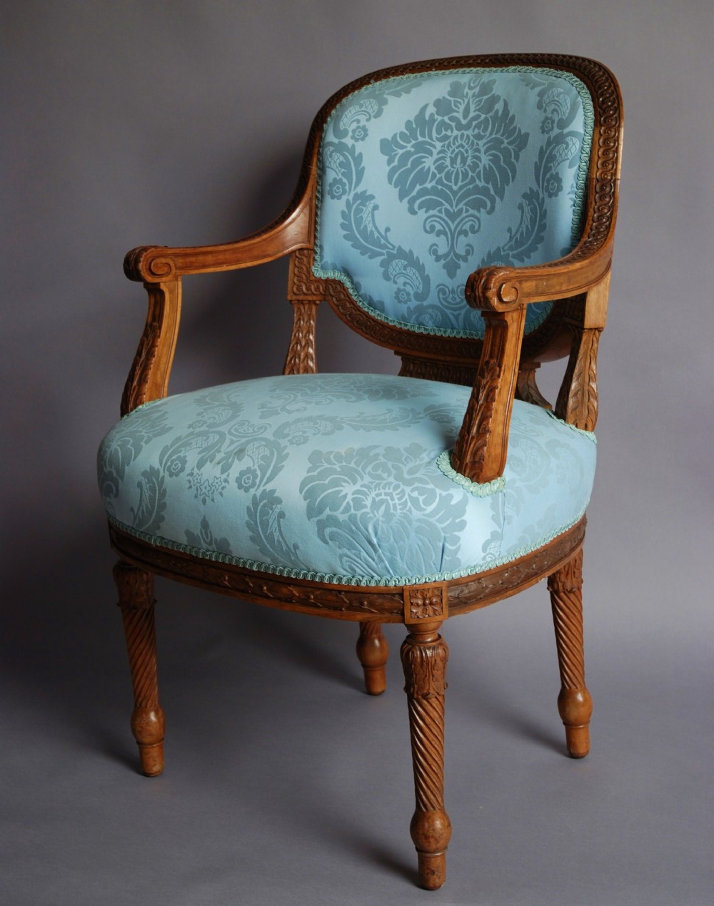 Late 19thc French walnut open armchair of excellent quality in blue silk upholstery.