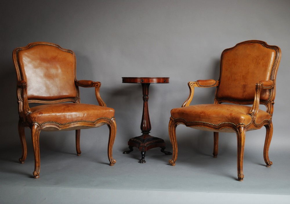 A late 19thc French pair of beech fauteuils (open armchairs) in the Louis XV style