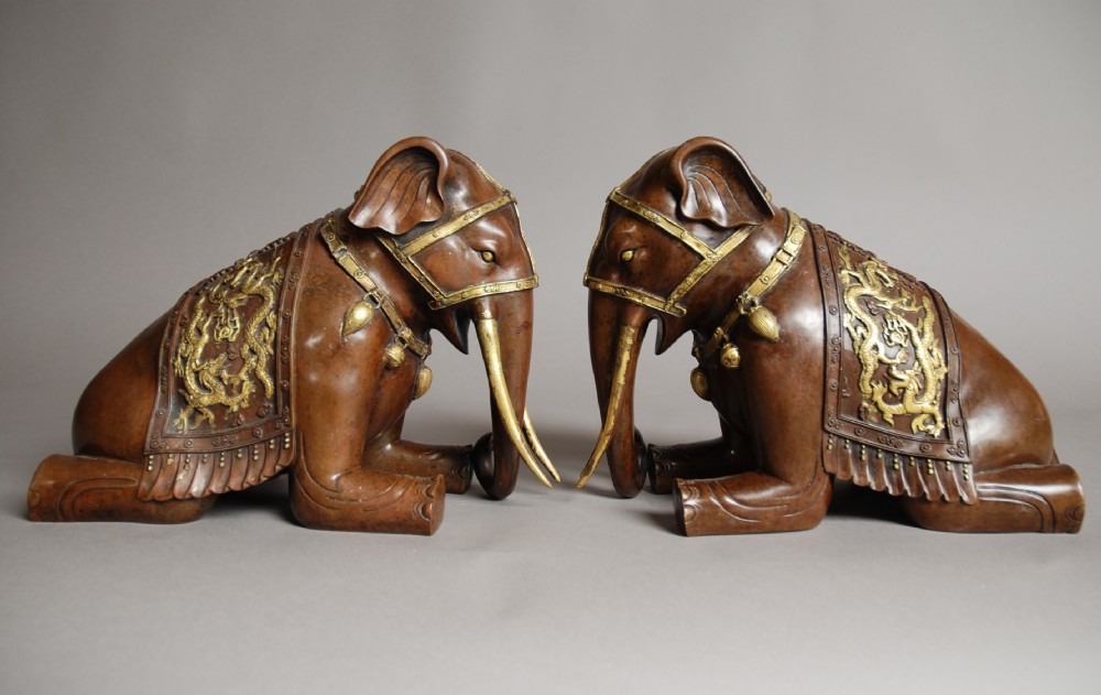 Pair of Chinese kneeling bronze & gilt elephants 