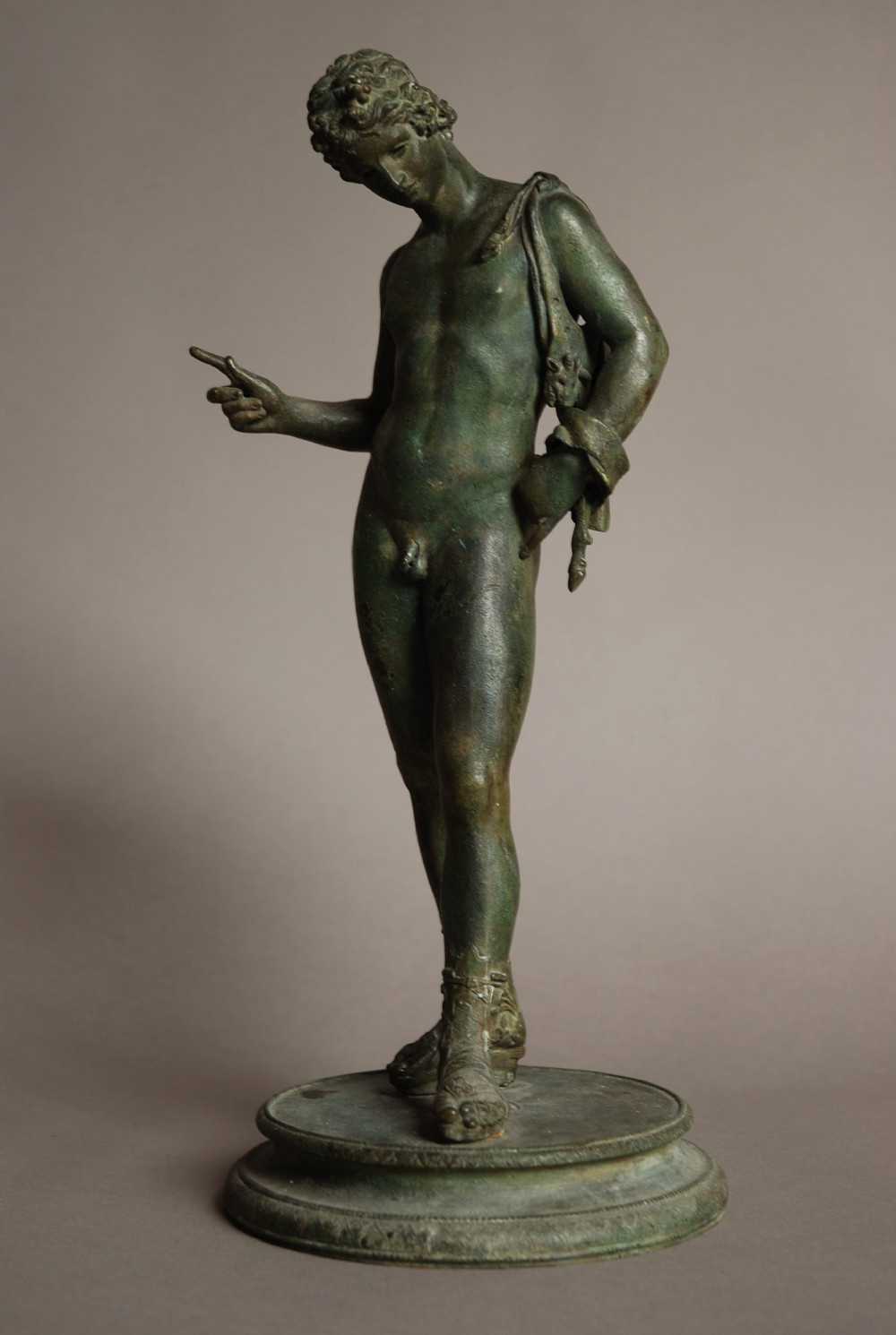 Bronze figure of Narcissus with green patination
