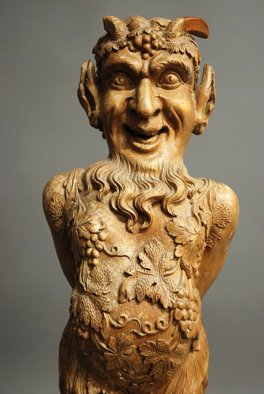 A large Continental decorative carved satyr figure