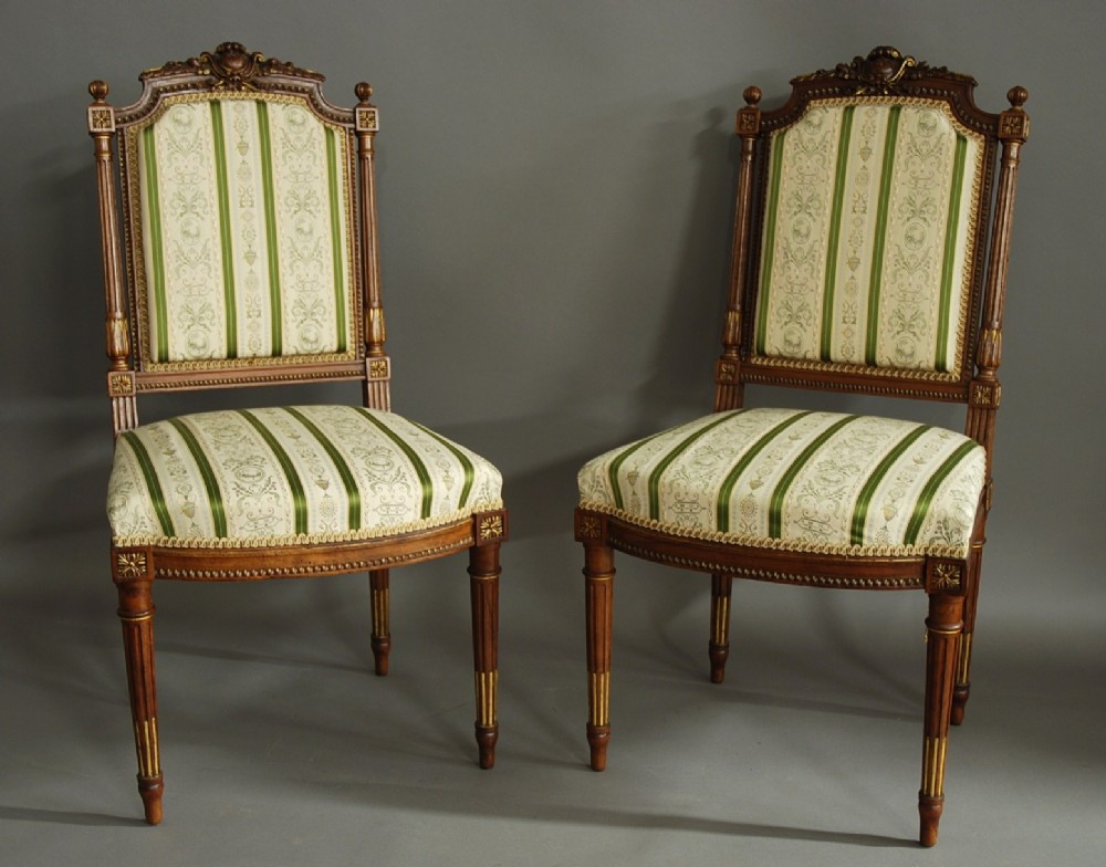 Pair of French carved walnut & parcel-gilt chairs in the Louis XVI style