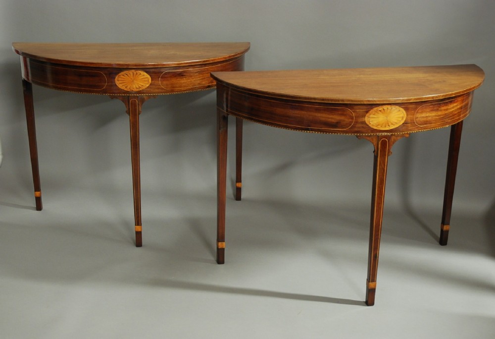 Pair of 18thc mahogany console tables of demilune form 