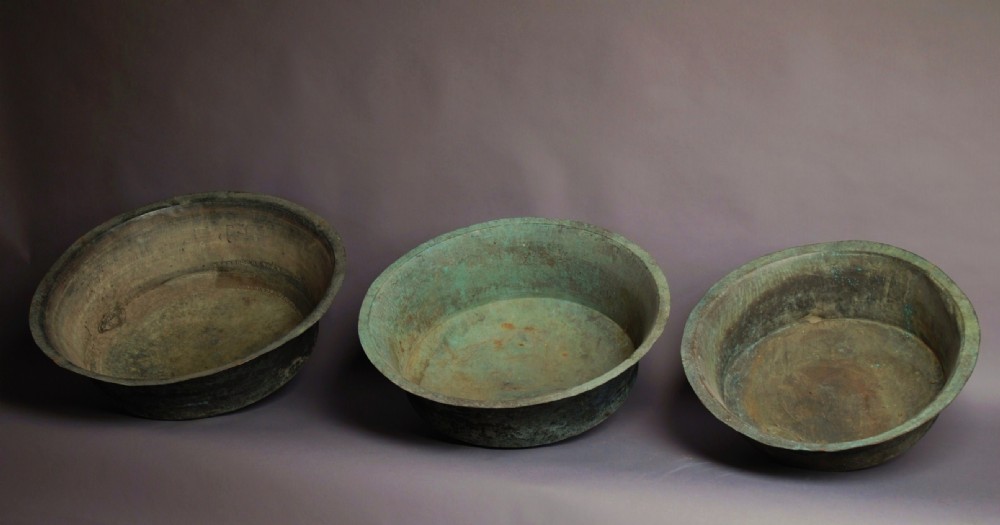 Three matched large decorative French graduated copper coppers