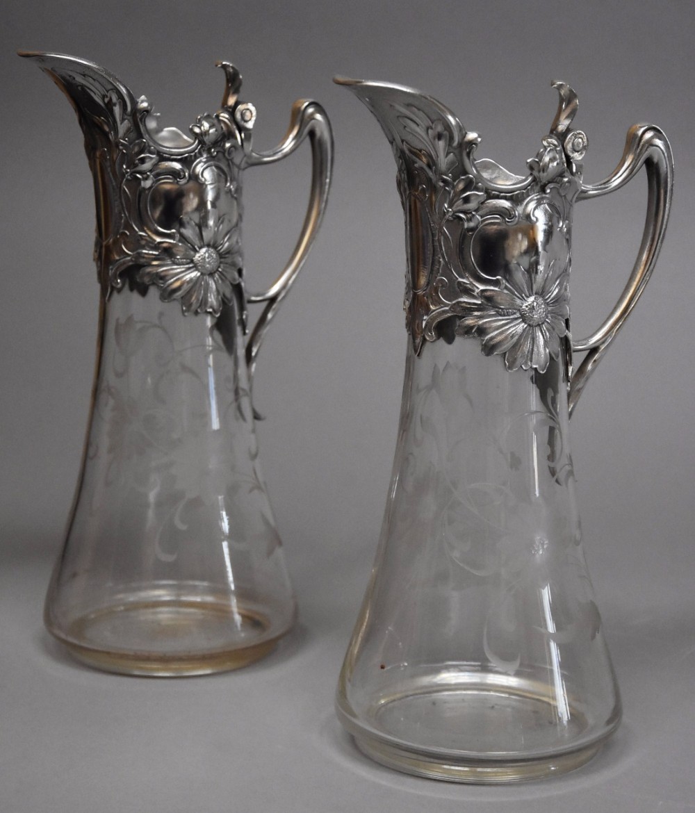 Pair of late 19thc silver plate mounted Art Nouveau claret jugs, stamped WMF