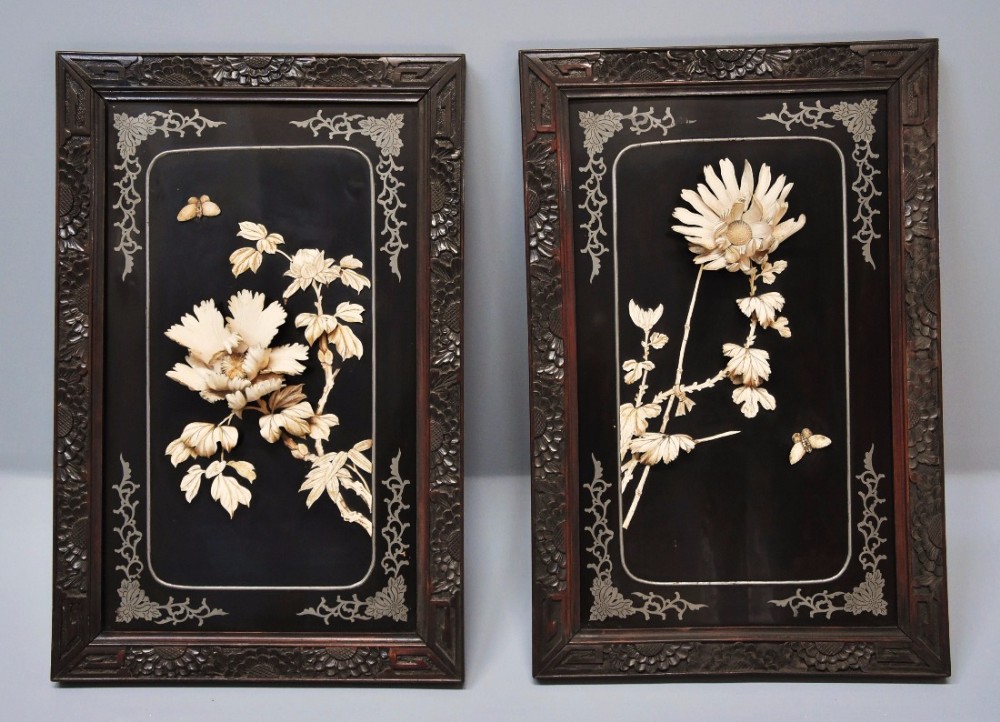 Pair of highly decorative late 19thc black lacquered panels with carved floral decoration