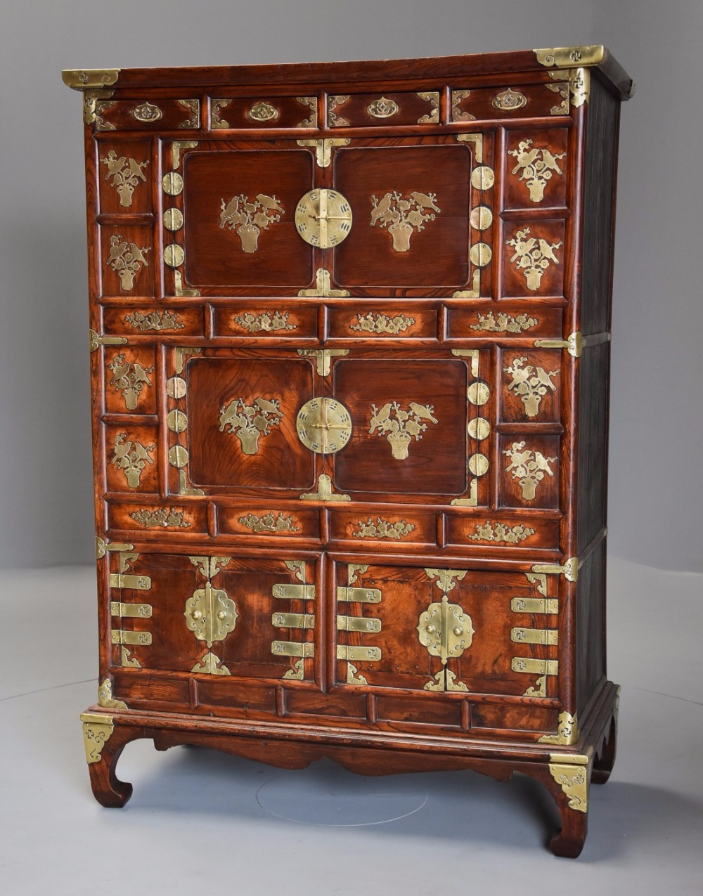 Highly decorative 19th century three tier Korean elm cabinet with brass decoration 