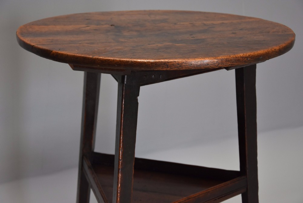 Late 18th century oak cricket table with shelf and of fine patina  View V