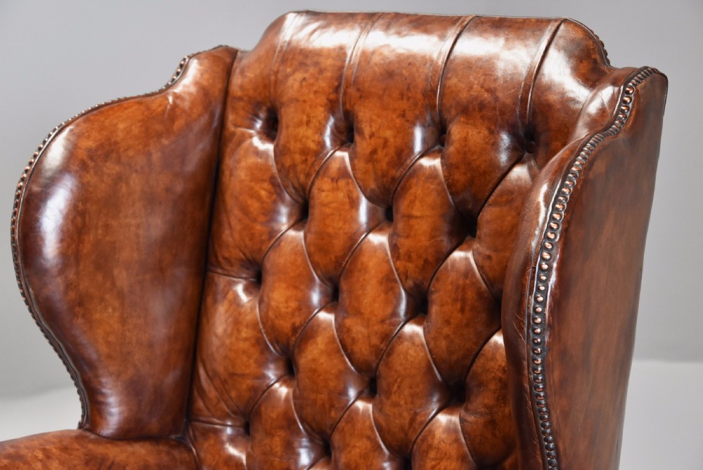 Early 20th century Georgian style deep buttoned brown leather wing armchair View VI