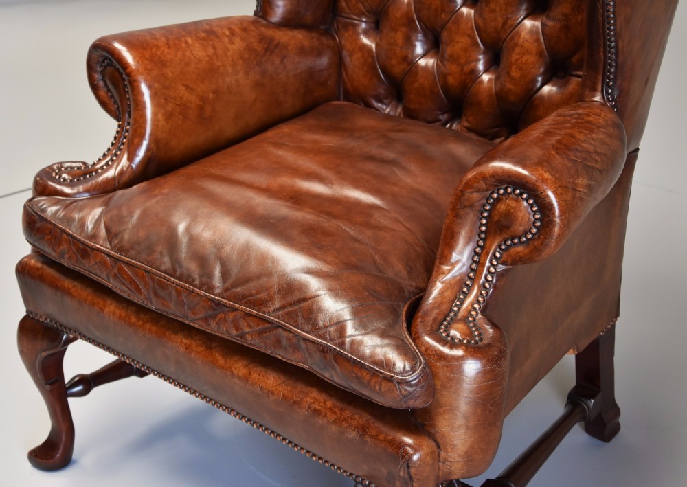 Early 20th century Georgian style deep buttoned brown leather wing armchair View VII