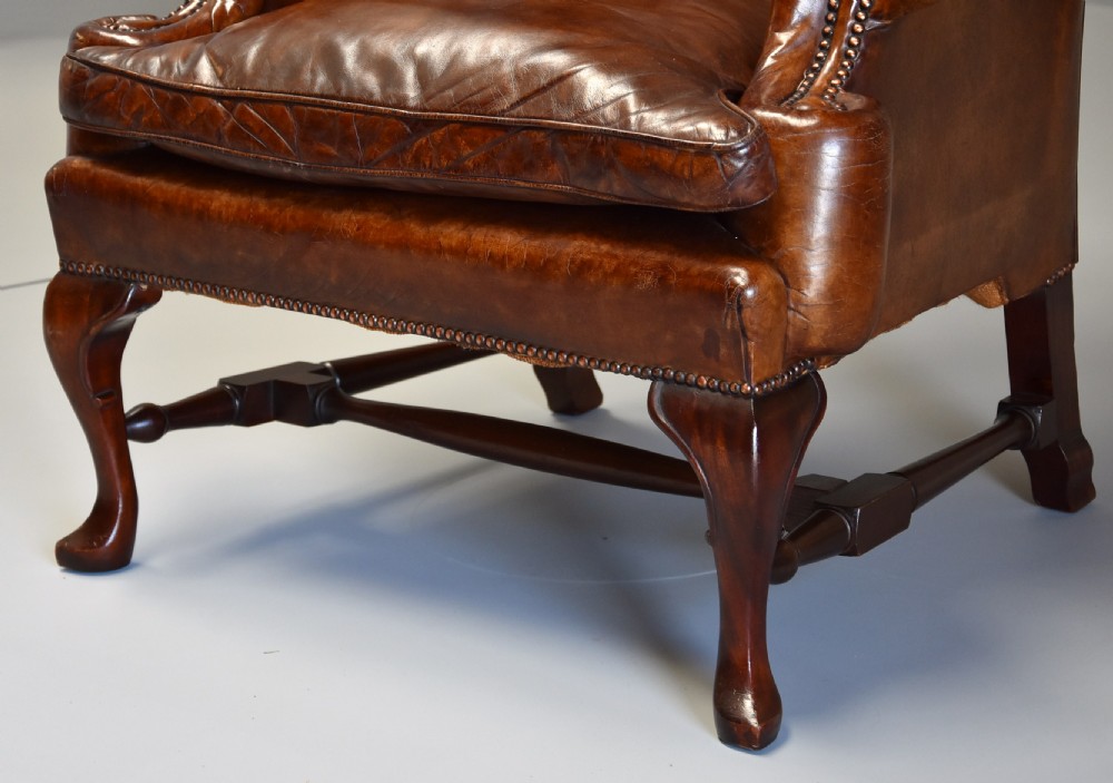 Early 20th century Georgian style deep buttoned brown leather wing armchair View VIII