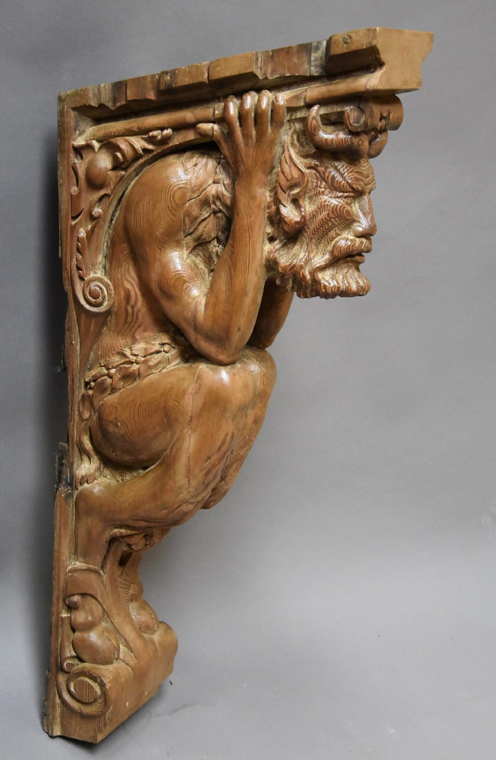 Large highly decorative superbly carved Continental pine bracket in the form of a satyr