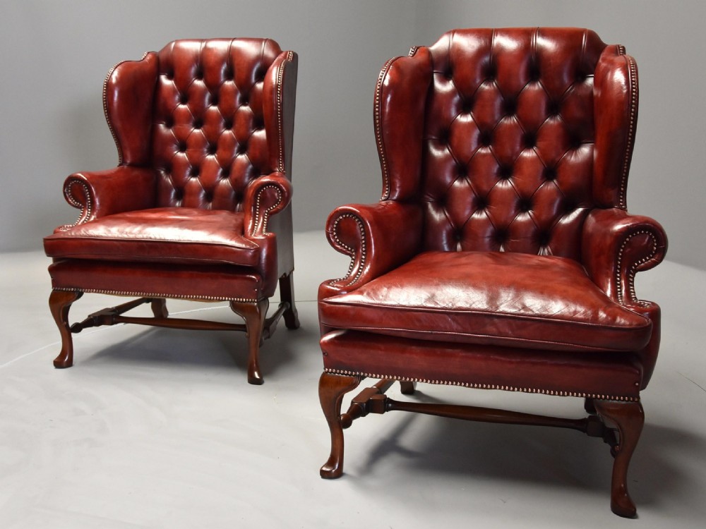 Superb pair of early 20th century Georgian style deep buttoned red leather wing armchairs