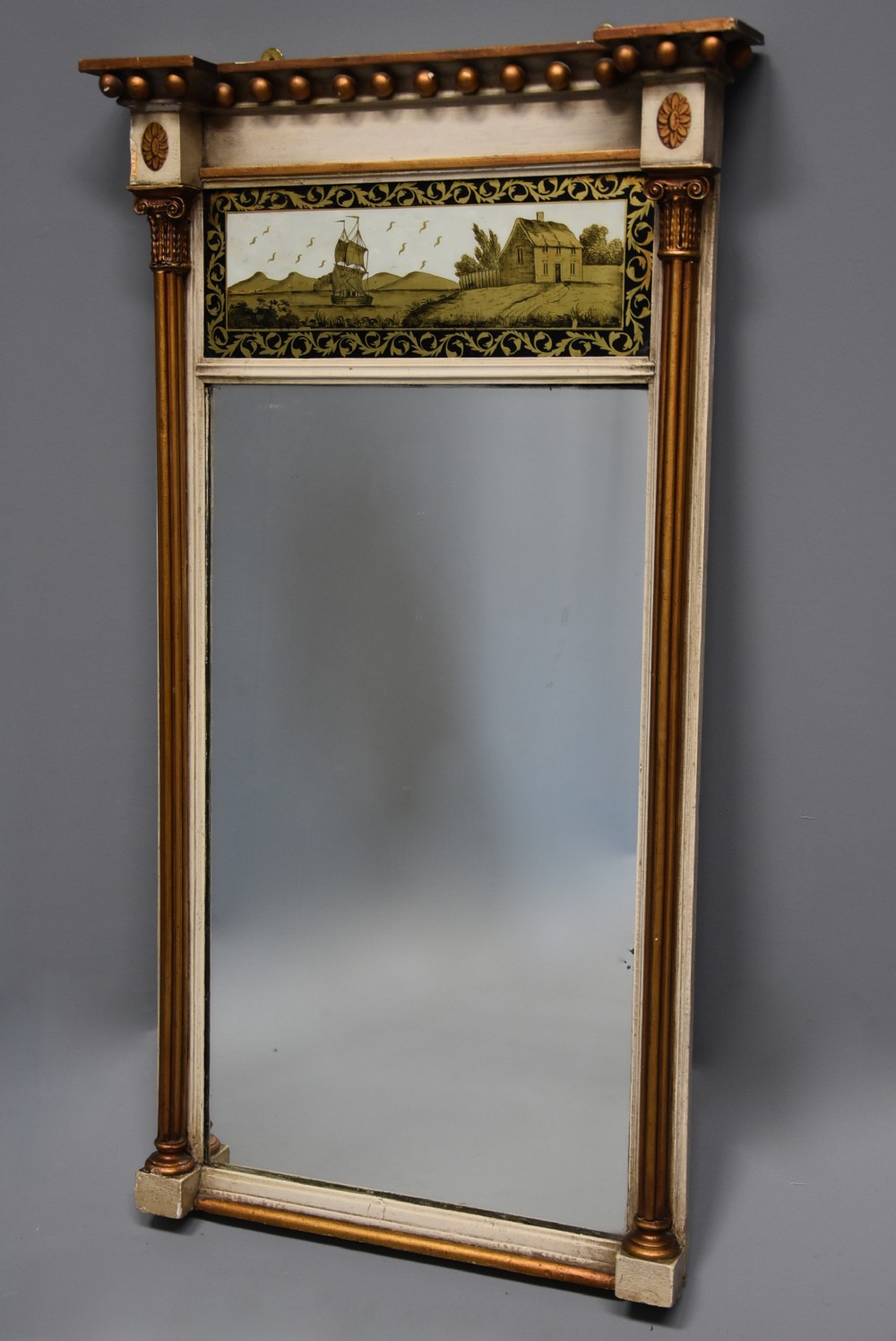 Early 19th century Regency eglomise, gilt and painted pier mirror