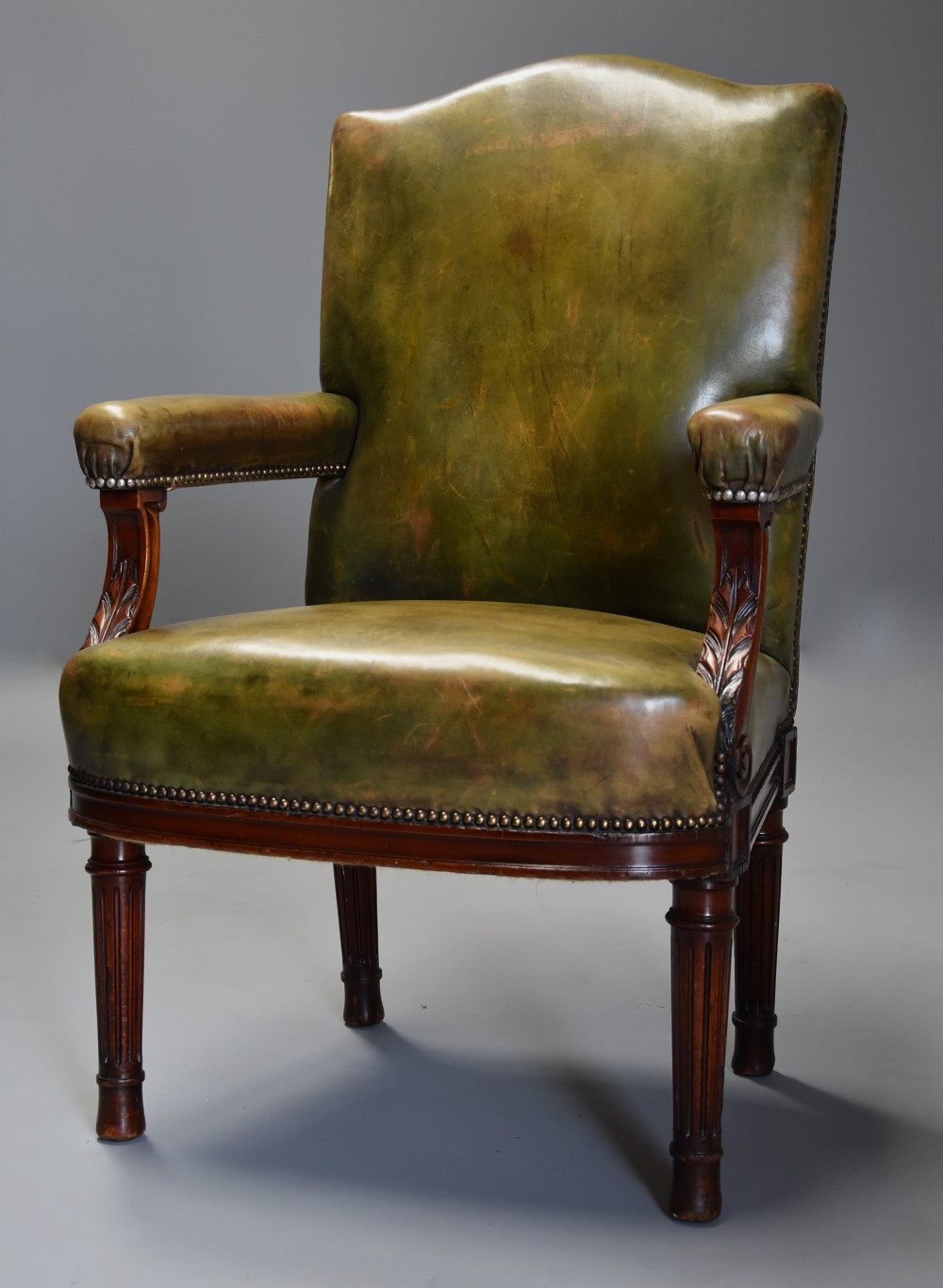 Late 19th century mahogany green leather open armchair