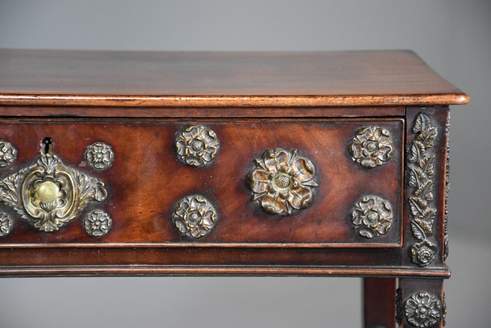 Highly decorative late 18th century mahogany side table with later applied brass paterae View X