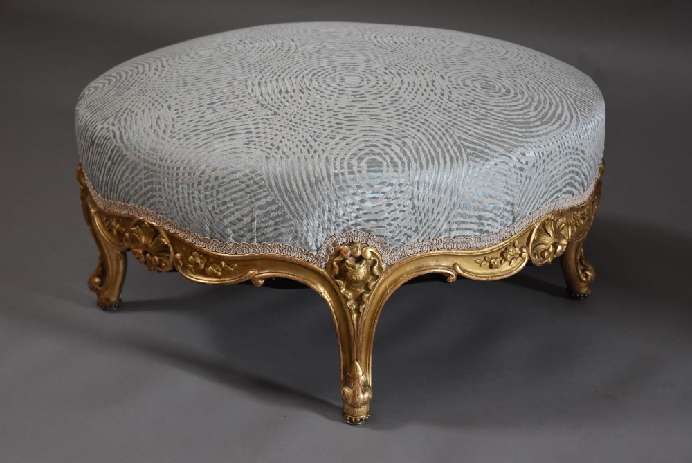 Large highly decorative 19th century French circular giltwood footstool in the Rococo style View II