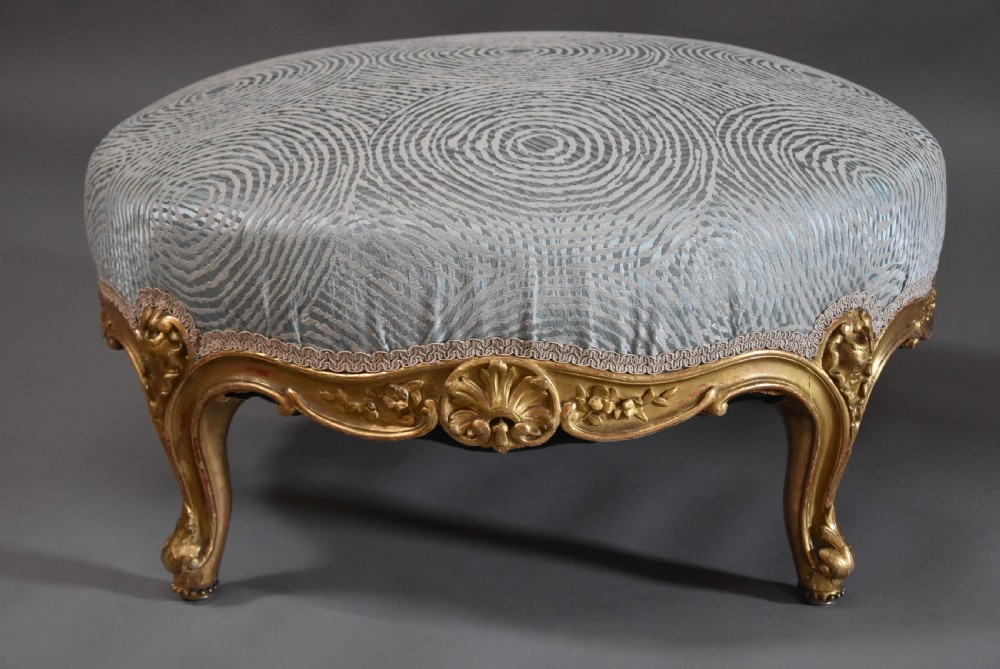 Large highly decorative 19th century French circular giltwood footstool in the Rococo style View III