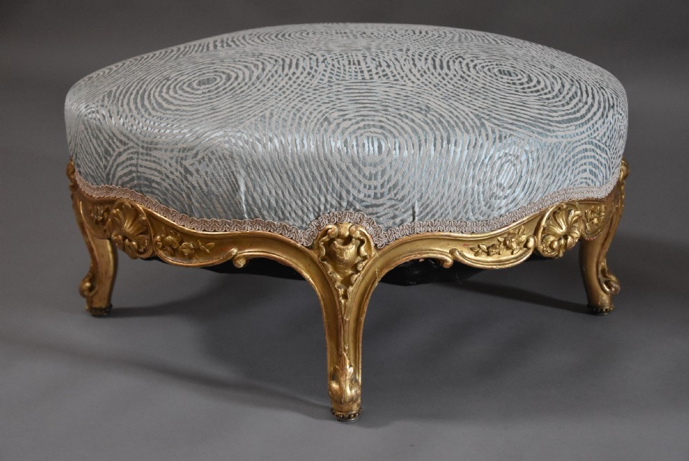 Large highly decorative 19th century French circular giltwood footstool in the Rococo style View V