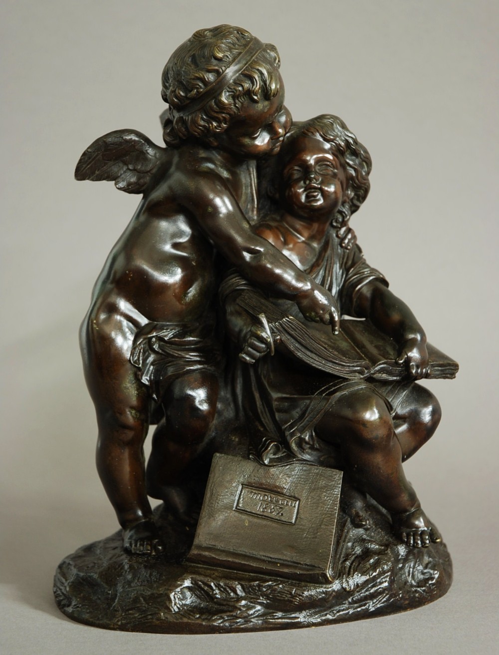 Mid 19thc French bronze of a putto next to a seated young girl, marked 'Moreau 1857'