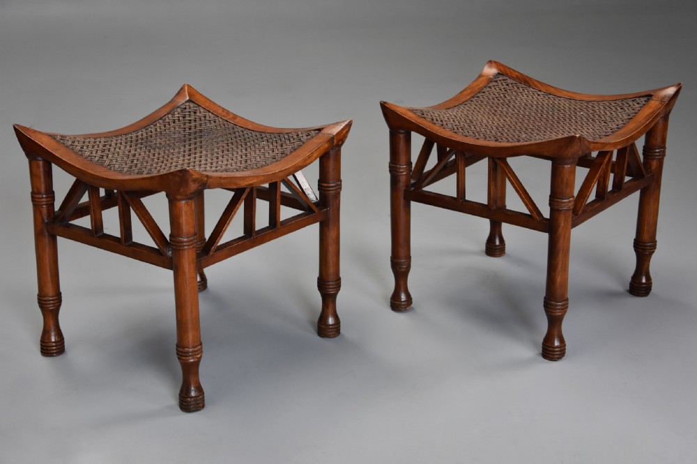 Pair of early 20th century walnut Thebes stools, designed by Liberty & Co.