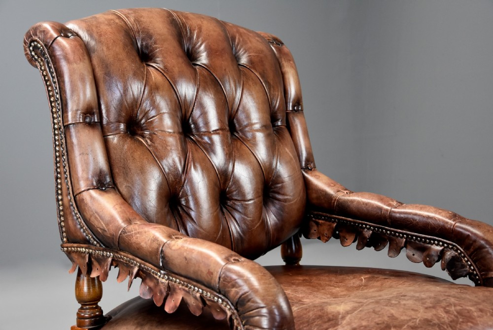 Highly decorative French brown leather open armchair, the leather of nicely worn appearance View VIII