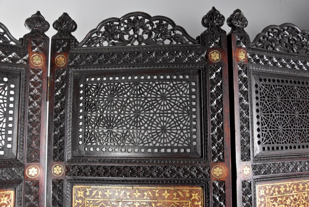 Fine quality 19thc Anglo Indian profusely carved padouk & brass inlaid four fold screen from Northern India View XII