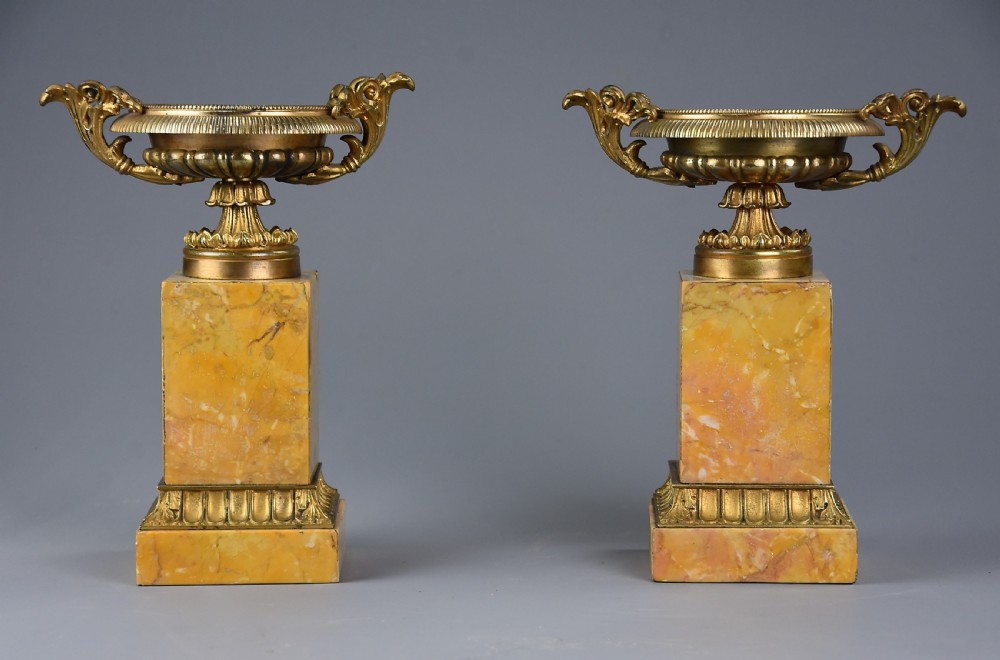 Pair of French highly decorative early 20thc gilt metal tazzas on marble bases in the Neoclassical style