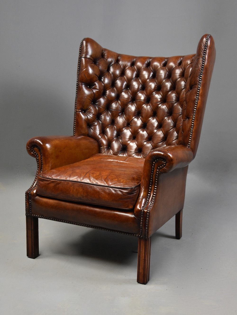 Edwardian deep button brown leather hall porter's chair in the Georgian style